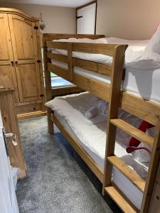 a couple of bunk beds in a room at The Dairy, quiet countryside location near York in Wilberfoss