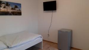 a bedroom with a bed and a flat screen tv at Wohnung für 6 Personen in Gevelsberg in Gevelsberg