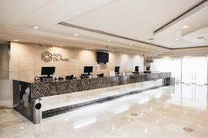 a lobby with a bar with computers on it at Hotel del Prado in Mexico City