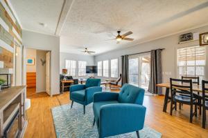 a living room with blue chairs and a table at Lakeside Cashiers Cabin with Private Boat Dock! in Cullowhee