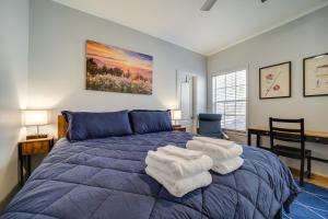 a bedroom with a blue bed with towels on it at Lakeside Cashiers Cabin with Private Boat Dock! in Cullowhee