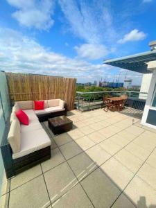 a patio with a couch and a table on a roof at Captivating 1-Bed Apartment in London in London