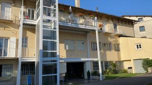 an apartment building with balconies on the side of it at Chez Hélène 3 étoiles, labellisé disabled PMR,pour 4 personnes chiens bienvenus-pet friendly in Bourg-Madame