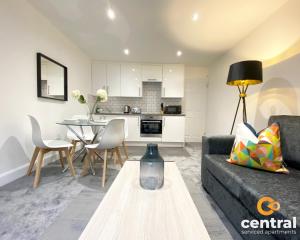 a living room with a couch and a table at 1 Bedroom Apartment by Central Serviced Apartments - Modern - FREE Street Parking - Close to University of Dundee - Weekly-Monthly Stay Offers - Wi-Fi - Cosy Little Apartment in Dundee
