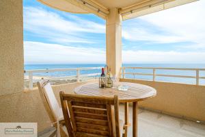 a table on a balcony with a view of the ocean at Cabo Mar Apartment sea view/pool in El Campello