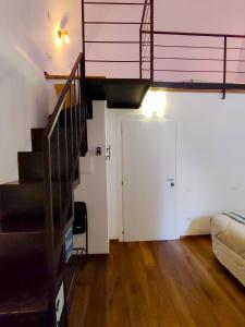 a living room with a staircase and a door at Stanza Con Bagno Privato Orvieto Centro Storico, Aria Condizionata NETFLIX Vicino al Pozzo della Cava-Affittacamere "Carvajal Rooms" in Orvieto