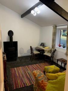a living room with a couch and a table at Dolgoch Mill House Annexe in Llanfair Caereinion