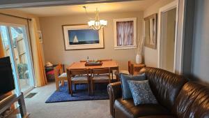 a living room with a couch and a dining room table at Sea to Sky in Burien