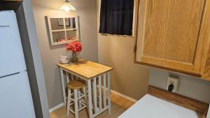 a small kitchen with a small table and a stool at Sea to Sky in Burien