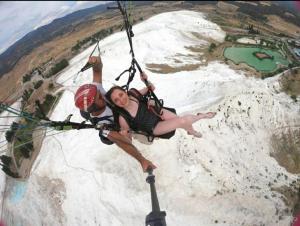 a woman is hanging from a rope on a rappeleport at HAPPY HOUSE 1 Pamukkale in Pamukkale +15 photos