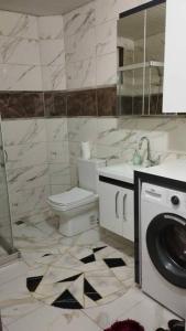 a bathroom with a toilet and a washing machine at HAPPY HOUSE 1 Pamukkale in Pamukkale
