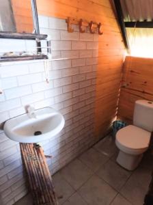 a bathroom with a sink and a toilet at Salomes cabaña baru in Playa Blanca