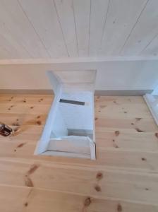 a white box sitting on the floor of a room at Charmigt hus och mysigt boende! in Hudiksvall