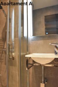 a bathroom with a sink and a shower at Apartament za 400m Plaża Sopot in Sopot