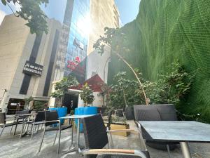 a group of tables and chairs in front of a building at Nour Al Thuria Hotel in Mecca