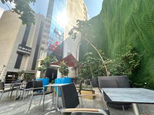 a group of tables and chairs in front of a building at Nour Althuria Hotel - Elaf Almaqam in Makkah