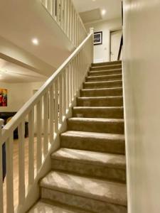 a stairway in a home with white stairs at Modern family home in Castleisland