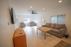 a living room with a couch and a table at Downtown Manhattan Beach Walk Street in Manhattan Beach