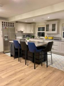 a kitchen with a table and blue chairs in it at Modern family home in Castleisland