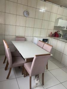 a white table and chairs in a kitchen at Casa de Everton e Tati in Triunfo +9 photos