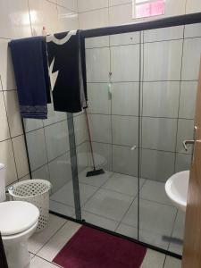 a bathroom with a glass shower with a toilet at Casa de Everton e Tati in Triunfo