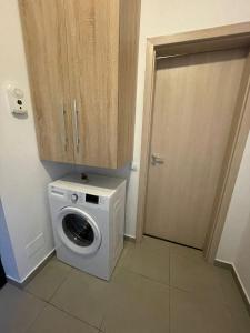 a washer and dryer in a room with a door at DARI Studio in Cluj-Napoca