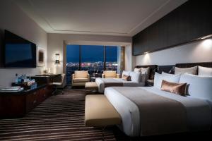 a hotel room with two beds and a living room at Red Rock Casino Resort & Spa in Las Vegas