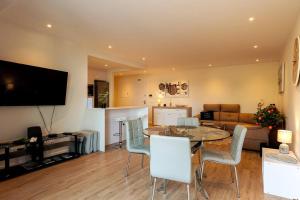 a living room with a table and chairs and a couch at Luxury and modern apartment in Porto Moniz center in Porto Moniz