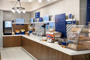a bakery counter in a store with food on display at Holiday Inn Express Simi Valley, an IHG Hotel in Simi Valley