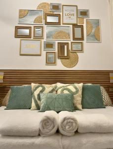 a couch with a bunch of pictures on a wall at Jerusalem Center in Jerusalem