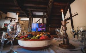 uma mesa com uma taça de fruta numa mesa com copos de vinho em Vila Chiflik Troyan em Troyan