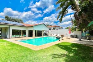 a swimming pool in the backyard of a house at Luxurious, spacious & central in Sandton