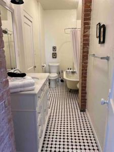 a bathroom with a sink and a toilet and a tub at Blue Bungalow near OU Med/Downtown in Oklahoma City