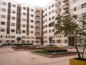 a courtyard in front of a building at Luminous & cosy studio - 5 mins from Mohammed V Airport in Nouaceur