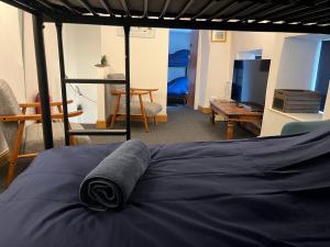 a bed with a towel on it in a room at Sweet Cottage in Ingleton