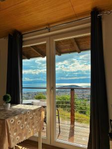 a sliding glass door with a view of the ocean at Cityview Unique Apartment Ohrid in Ohrid