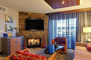 a living room with a fireplace and a television at Holiday Inn Club Vacations at Desert Club Resorts in Las Vegas