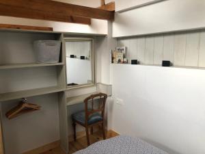 a small room with a chair and a window at Dépendance de charme - Tiny house in Colmar