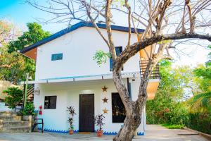 a white house with a blue roof at Olas Permanentes Buena Vista El Zonte in El Zonte