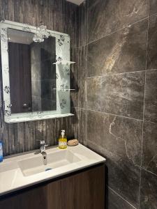 a bathroom with a sink and a mirror at Luminous & cosy studio - 5 mins from Mohammed V Airport in Nouaceur