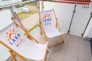 two chairs and a sign for laba at a convention at LABA Kołobrzeg Bliżej Morza in Kołobrzeg