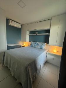 a bedroom with a bed with two lights on it at Cumbuco Ap VGSUN 402 in Cumbuco