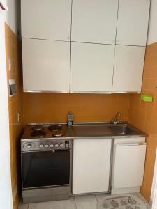 a kitchen with a stove and a sink at Casina mare bibbona in Marina di Bibbona
