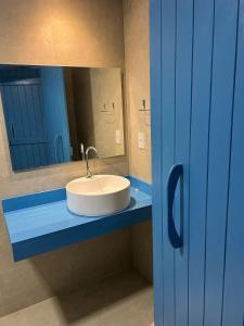 a bathroom with a white sink and a mirror at KEFI POUSADA in Maragogi