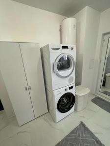 a washing machine and a washer in a kitchen at Двустаен апартамент за двама. in Burgas