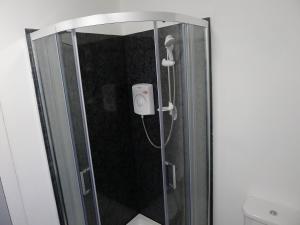 a shower in a bathroom with a glass door at Saltoun House in Fraserburgh