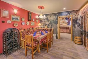 a dining room with red walls and a table and chairs at Hotel Resort Martin & Kristyna in Špindlerův Mlýn