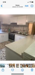 a kitchen with white cabinets and a counter top at Freddy's Suite in Ciudad Nezahualcóyotl