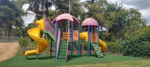 a playground with a slide in a park at Radio Hotel Resort & Convention in Serra Negra