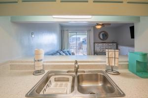 a kitchen counter with a sink in a kitchen at Condo in the heart of Downtown Carolina Beach in Carolina Beach